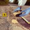 forensic technician using Trackrite Forensics Casting Material to cast tire tracks